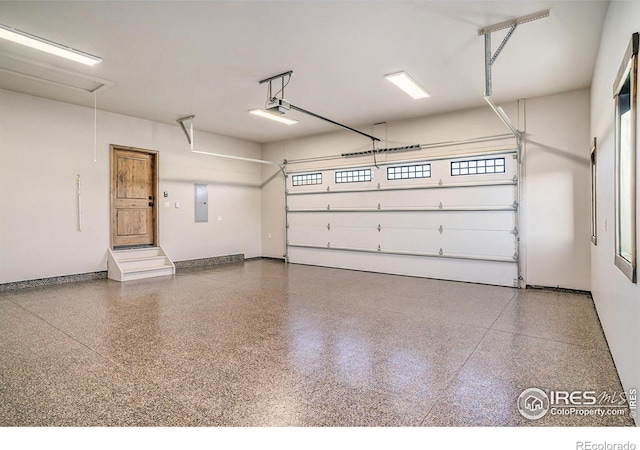 garage featuring electric panel and a garage door opener