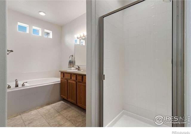 bathroom with vanity, shower with separate bathtub, and tile patterned floors