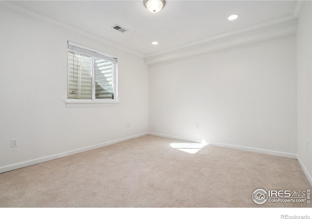 unfurnished room featuring light carpet and ornamental molding