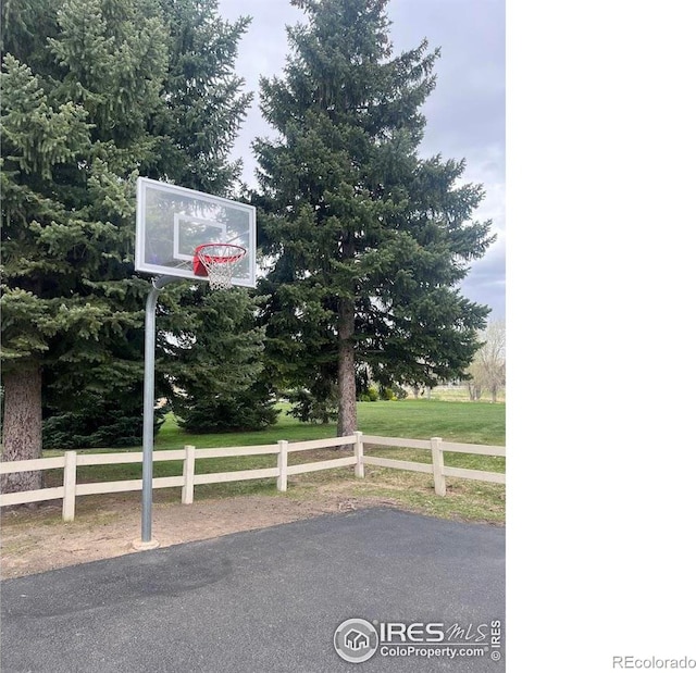 view of basketball court featuring a yard