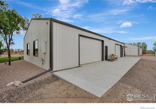 garage featuring wood walls