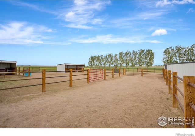 view of yard with a rural view and an outdoor structure