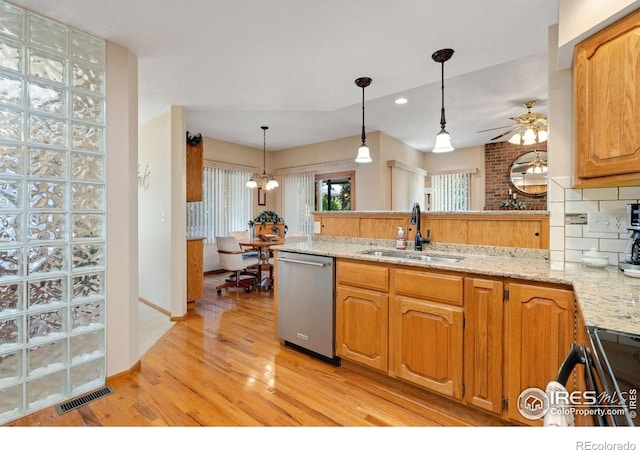 kitchen featuring sink, light hardwood / wood-style flooring, backsplash, dishwasher, and light stone countertops