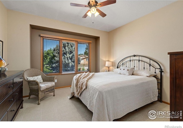 bedroom with ceiling fan and light colored carpet