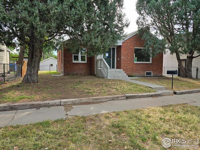 bungalow-style house with a front lawn