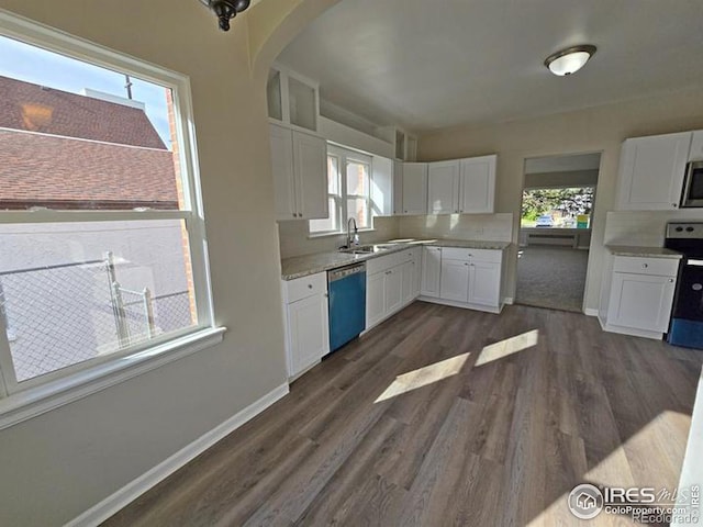 kitchen featuring backsplash, dark wood-type flooring, stainless steel appliances, and white cabinets