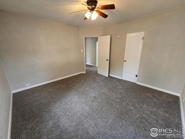 unfurnished bedroom featuring ceiling fan, a textured ceiling, and dark carpet