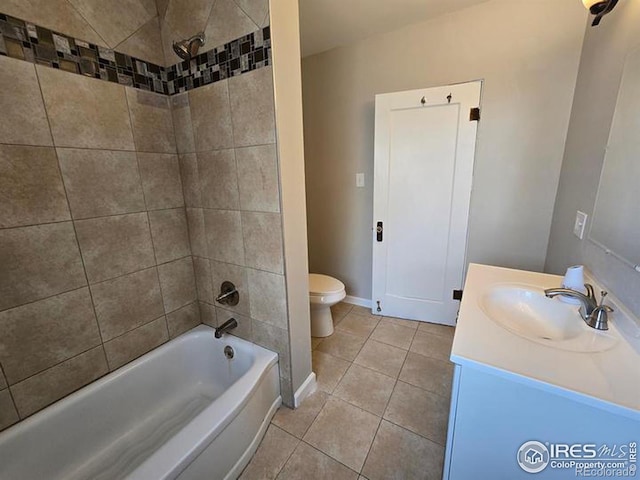bathroom with tile patterned flooring, toilet, vanity, shower / washtub combination, and baseboards