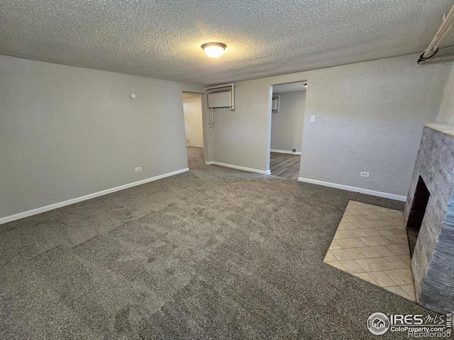 unfurnished living room featuring a textured ceiling and carpet flooring