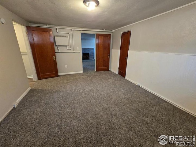 carpeted empty room featuring a textured ceiling