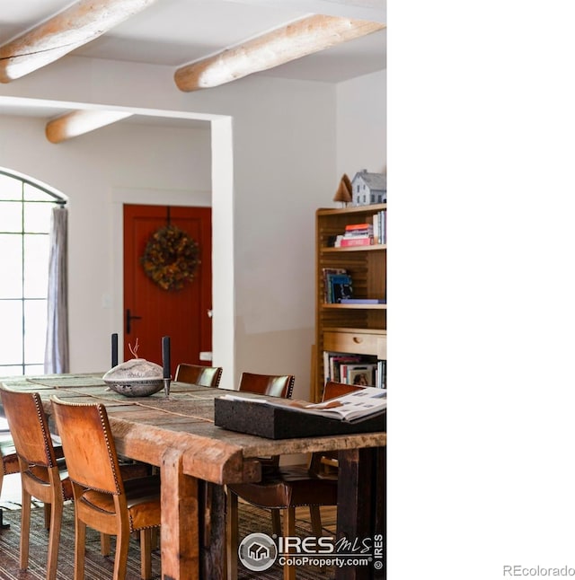 dining area with beam ceiling