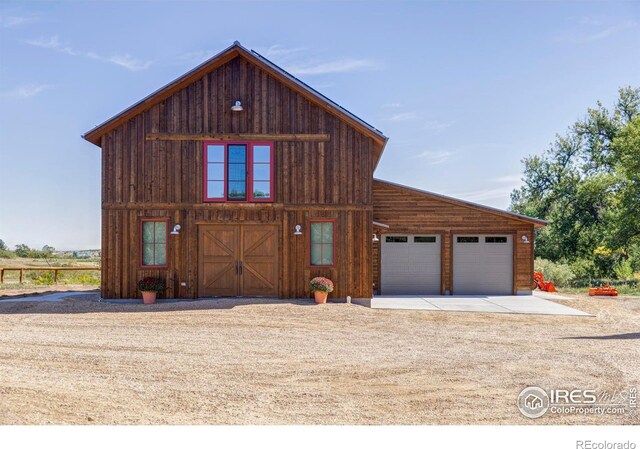 view of front facade with an outbuilding and a garage