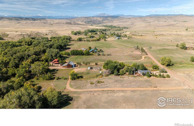 drone / aerial view featuring a mountain view and a rural view