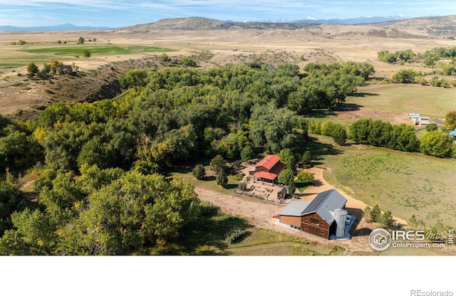 drone / aerial view with a mountain view and a rural view