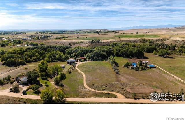 drone / aerial view featuring a mountain view and a rural view