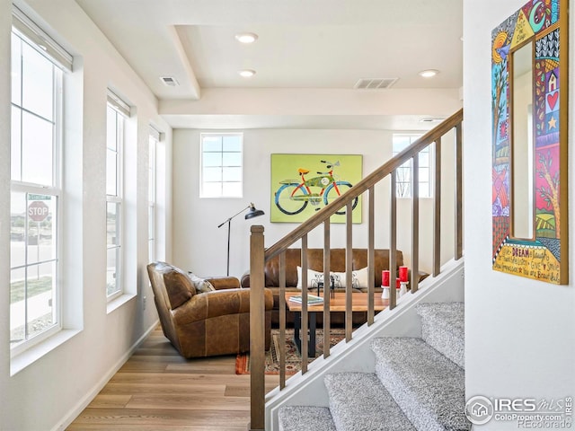 staircase with hardwood / wood-style flooring and a wealth of natural light