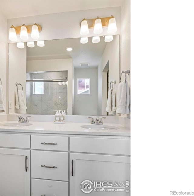 bathroom with walk in shower, vanity, and plenty of natural light