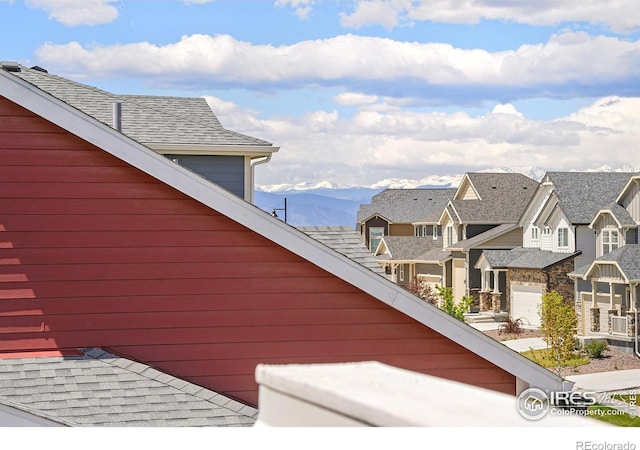 view of property exterior with a mountain view and a garage