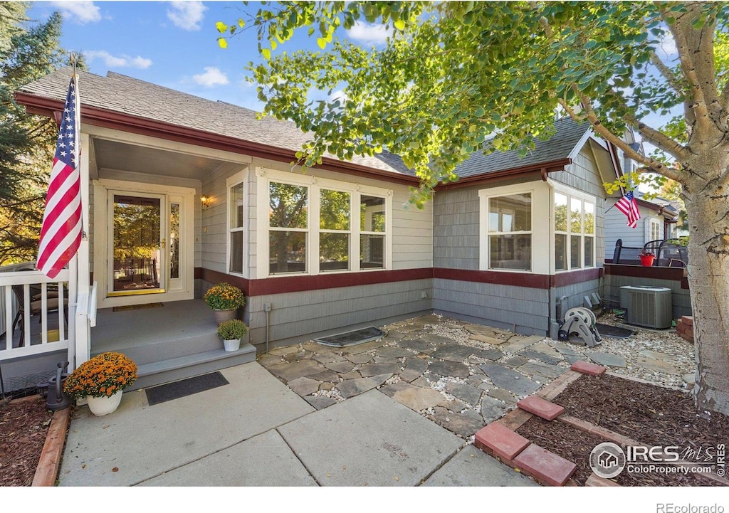 exterior space with cooling unit and a patio