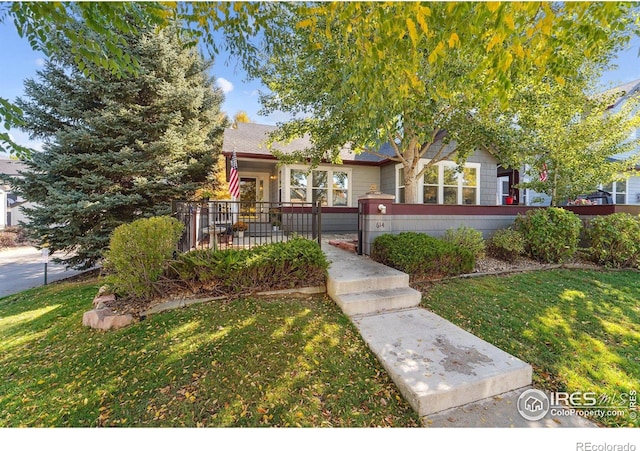 view of property hidden behind natural elements with a front lawn