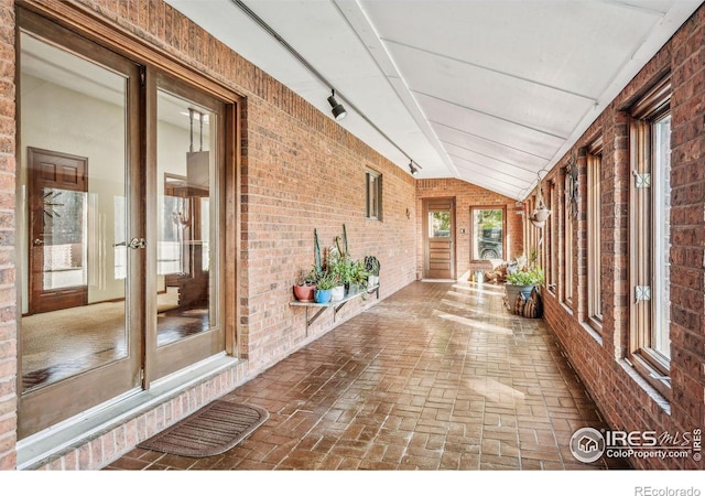 unfurnished sunroom with vaulted ceiling