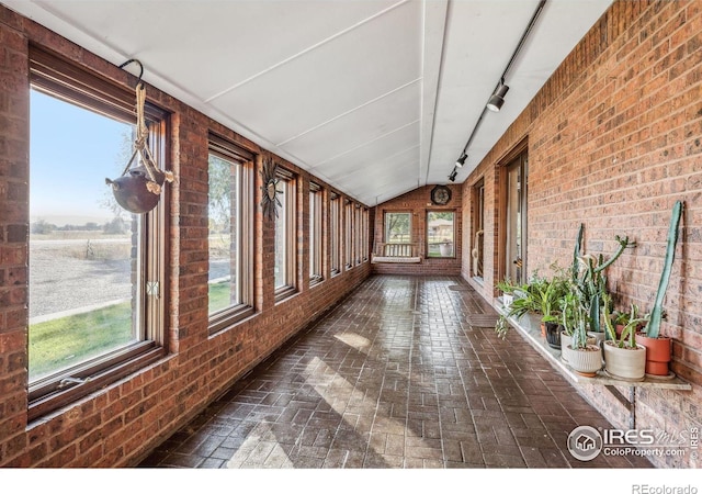 unfurnished sunroom with a wealth of natural light and vaulted ceiling