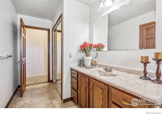 bathroom with tile patterned flooring and vanity