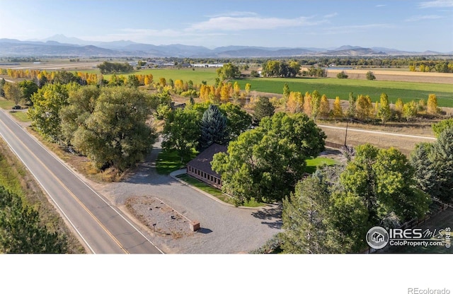 drone / aerial view featuring a rural view and a mountain view