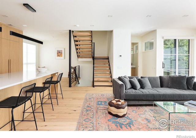 living room with light wood-type flooring and a barn door