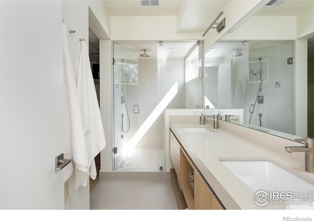 bathroom featuring vanity, tile patterned flooring, and an enclosed shower