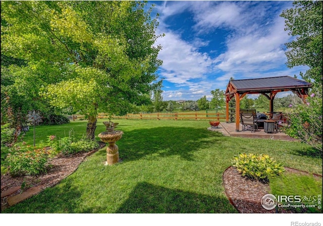 view of yard featuring a gazebo, a patio, and a fenced backyard