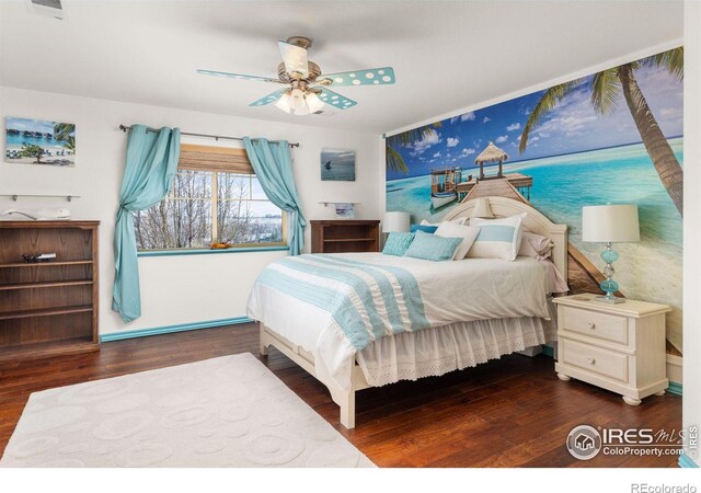 bedroom with ceiling fan and dark wood-type flooring