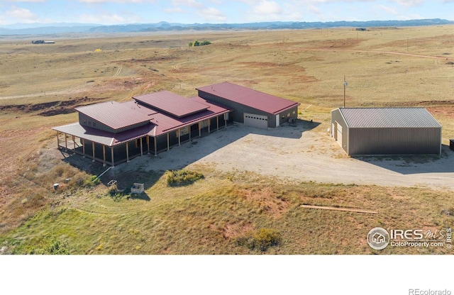 drone / aerial view featuring a rural view and a mountain view