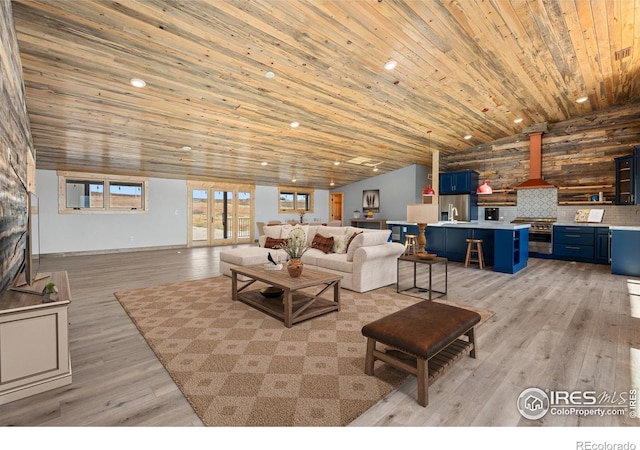 living room featuring wooden ceiling, light hardwood / wood-style floors, and vaulted ceiling