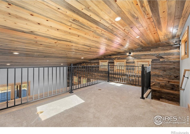 additional living space featuring carpet floors, wood ceiling, and wood walls