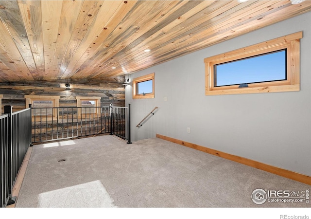 bonus room featuring lofted ceiling, wood walls, wooden ceiling, and carpet floors