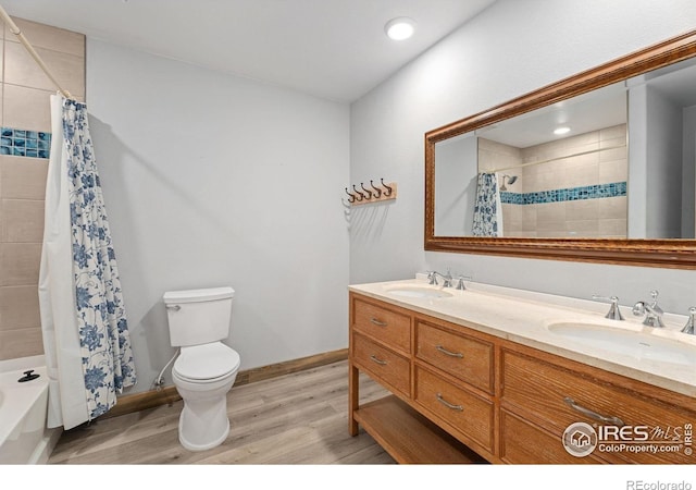 full bathroom featuring shower / bath combination with curtain, vanity, hardwood / wood-style floors, and toilet