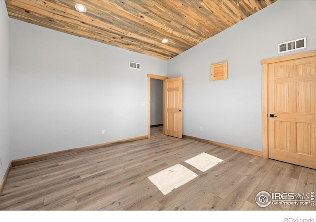 unfurnished bedroom featuring vaulted ceiling, light hardwood / wood-style floors, and wooden ceiling