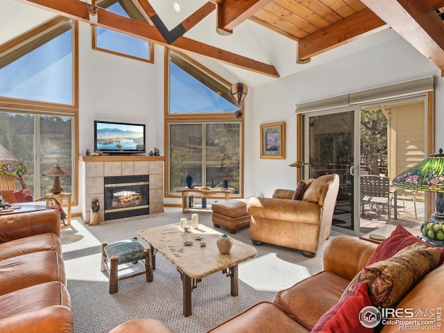 living room featuring a fireplace, beam ceiling, carpet, and high vaulted ceiling