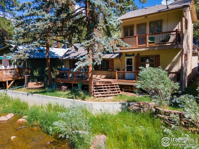 back of property with a wooden deck