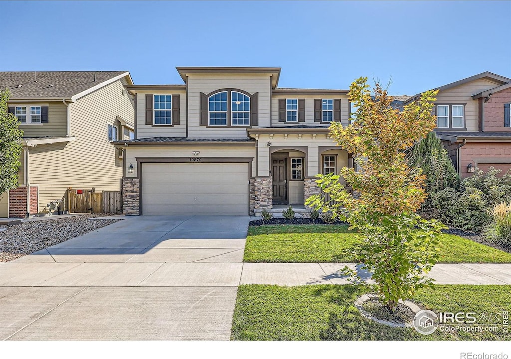 view of front of property with a front lawn and a garage