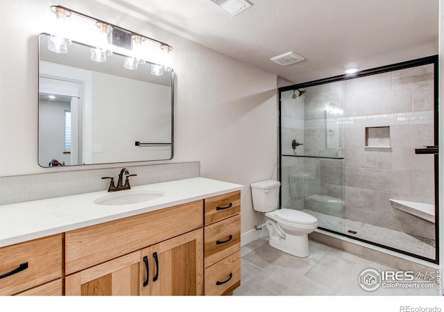 full bathroom featuring visible vents, vanity, toilet, and a shower stall