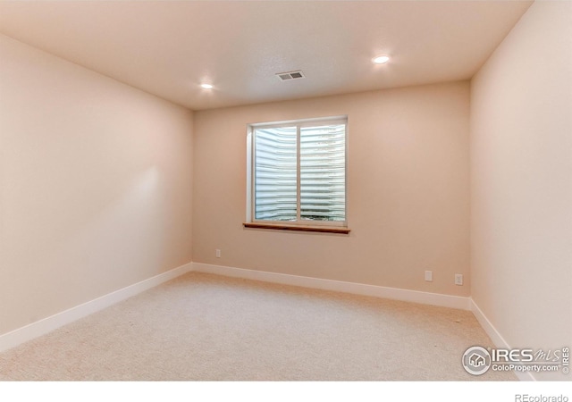 spare room with recessed lighting, visible vents, baseboards, and carpet flooring