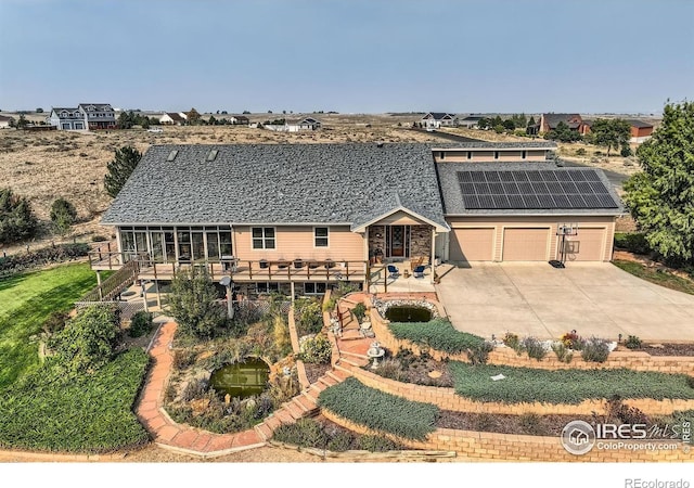 view of front of home featuring solar panels and a patio area