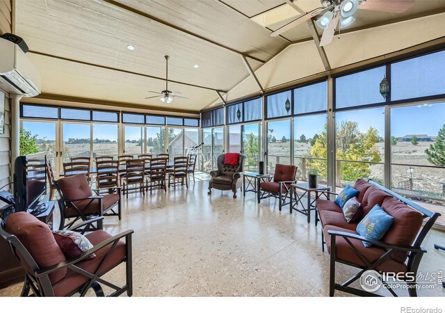 sunroom / solarium with ceiling fan, vaulted ceiling, and a wall mounted AC