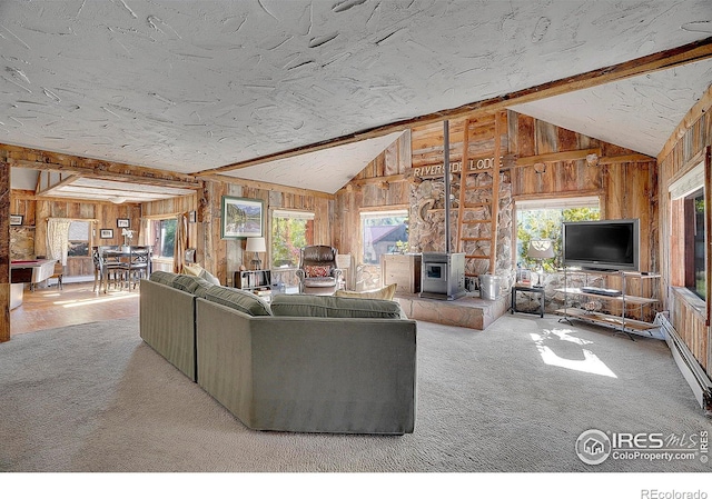 unfurnished living room featuring light carpet, lofted ceiling with beams, and a wood stove