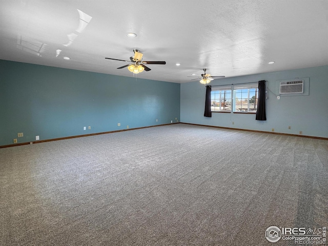 carpeted empty room with baseboards, recessed lighting, ceiling fan, and a wall mounted air conditioner
