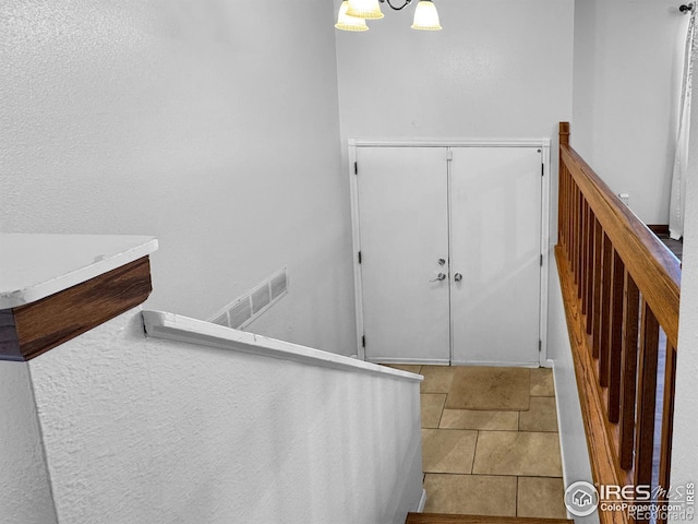 staircase featuring visible vents