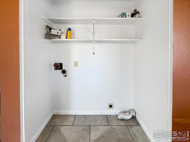 clothes washing area featuring tile patterned floors, laundry area, hookup for a washing machine, baseboards, and electric dryer hookup