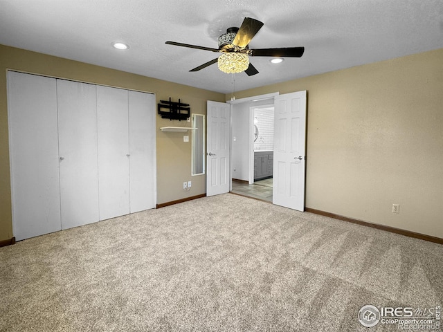 unfurnished bedroom featuring carpet, a closet, baseboards, and ceiling fan